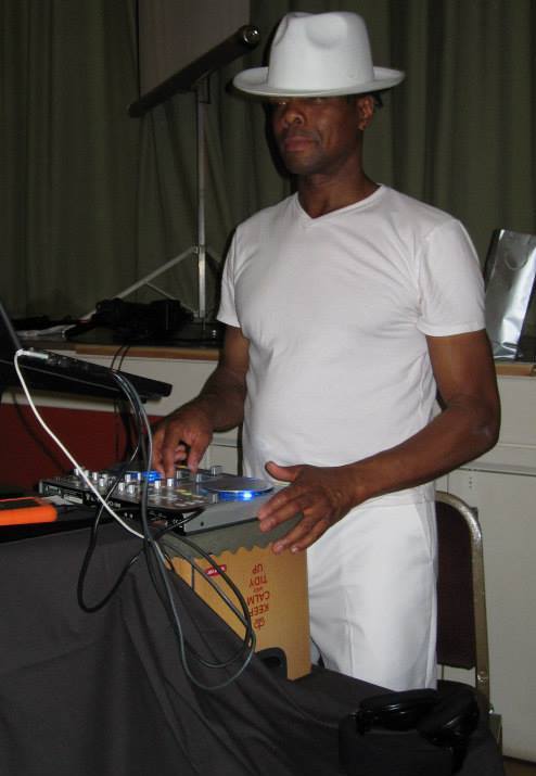 Leroy all in white in full DJ flow.